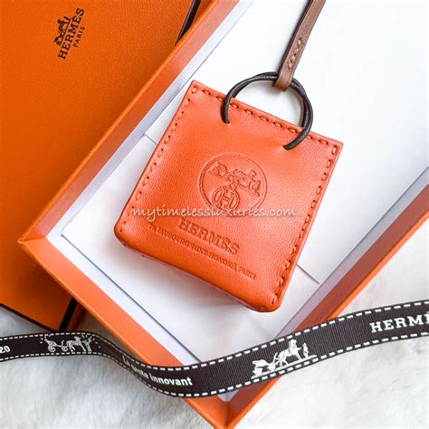 hermes orange shopping bag charm|hermes bag charms history.